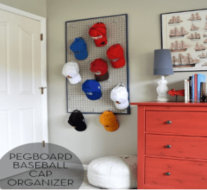 A baseball cap organizer is hung on the wall.